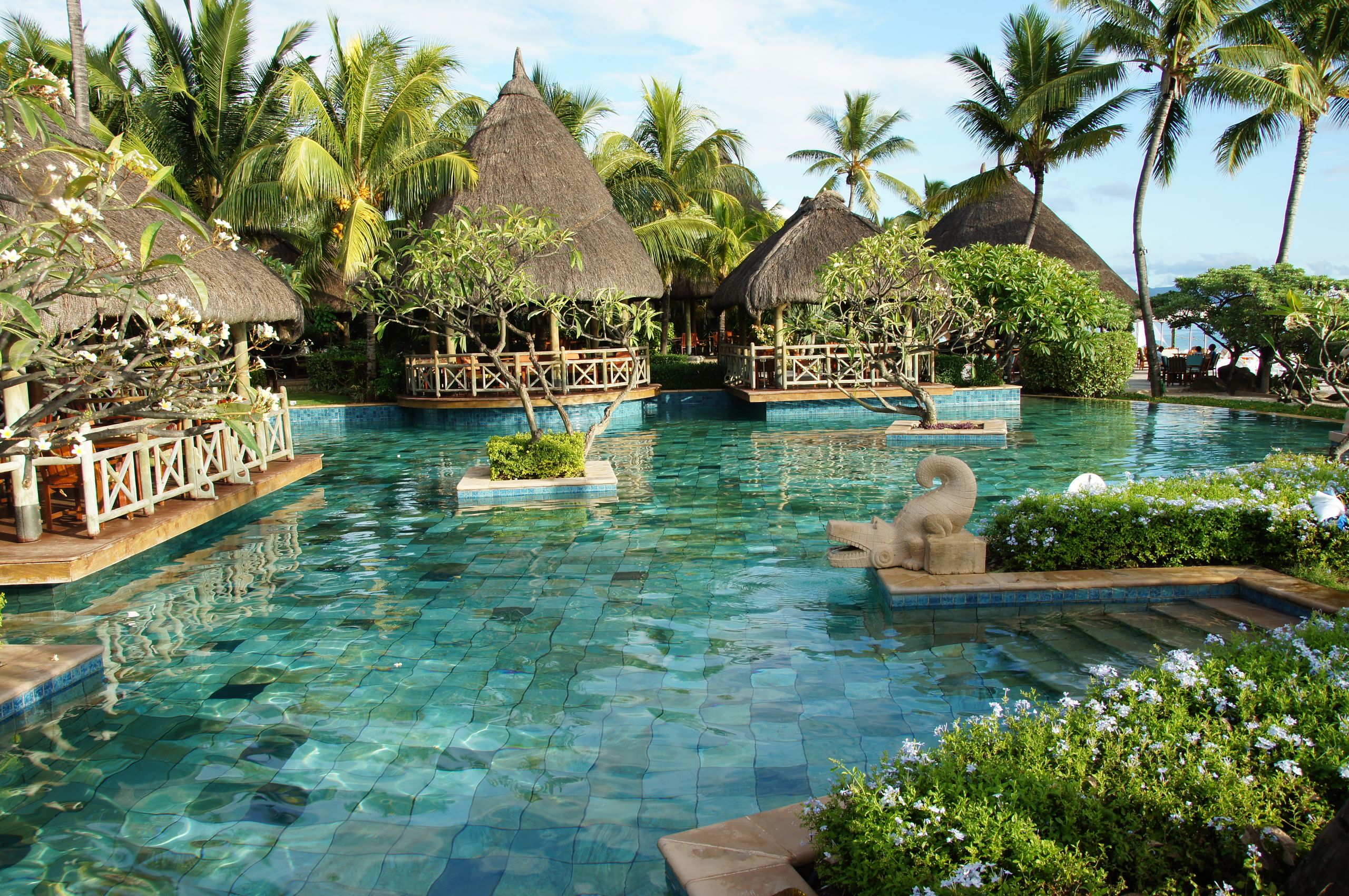 Experience luxury and relaxation at a tropical resort pool in Flic en Flac, Mauritius.